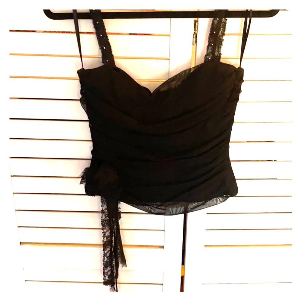 Black corset type top with lace flower detail.